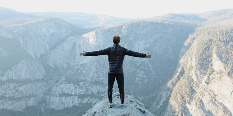 a-man-standing-on-the-peak