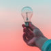 a-person-holding-the-light-bulb
